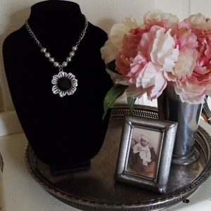 Silver flower necklace with stones.